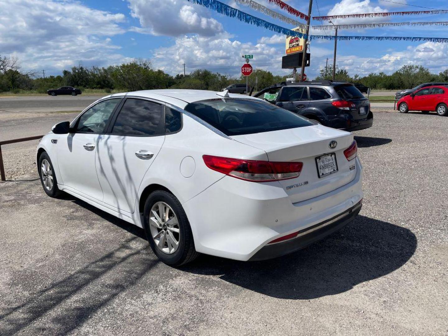 2016 WHITE KIA OPTIMA LX (5XXGT4L33GG) with an 2.4L engine, Automatic transmission, located at 124 Elm St., Cibolo, TX, 78108, (210) 658-3118, 29.559427, -98.232384 - www.discountautoscibolo.com TEXT QUESTIONS TO 210-900-3118 35 MONTHLY PAYMENTS OF $300 WITH $2295 DOWN AND FINAL ODD PAYMENT OF $214.30 W/FIRST PAYMENT DUE 30 DAYS FROM DATE OF SALE. ** NO WARRANTY, SOLD AS IS ** 36 MO'S TERM W/ 22.32 APR and TITLE TRANSFER FEE OF $245 DUE - Photo#2