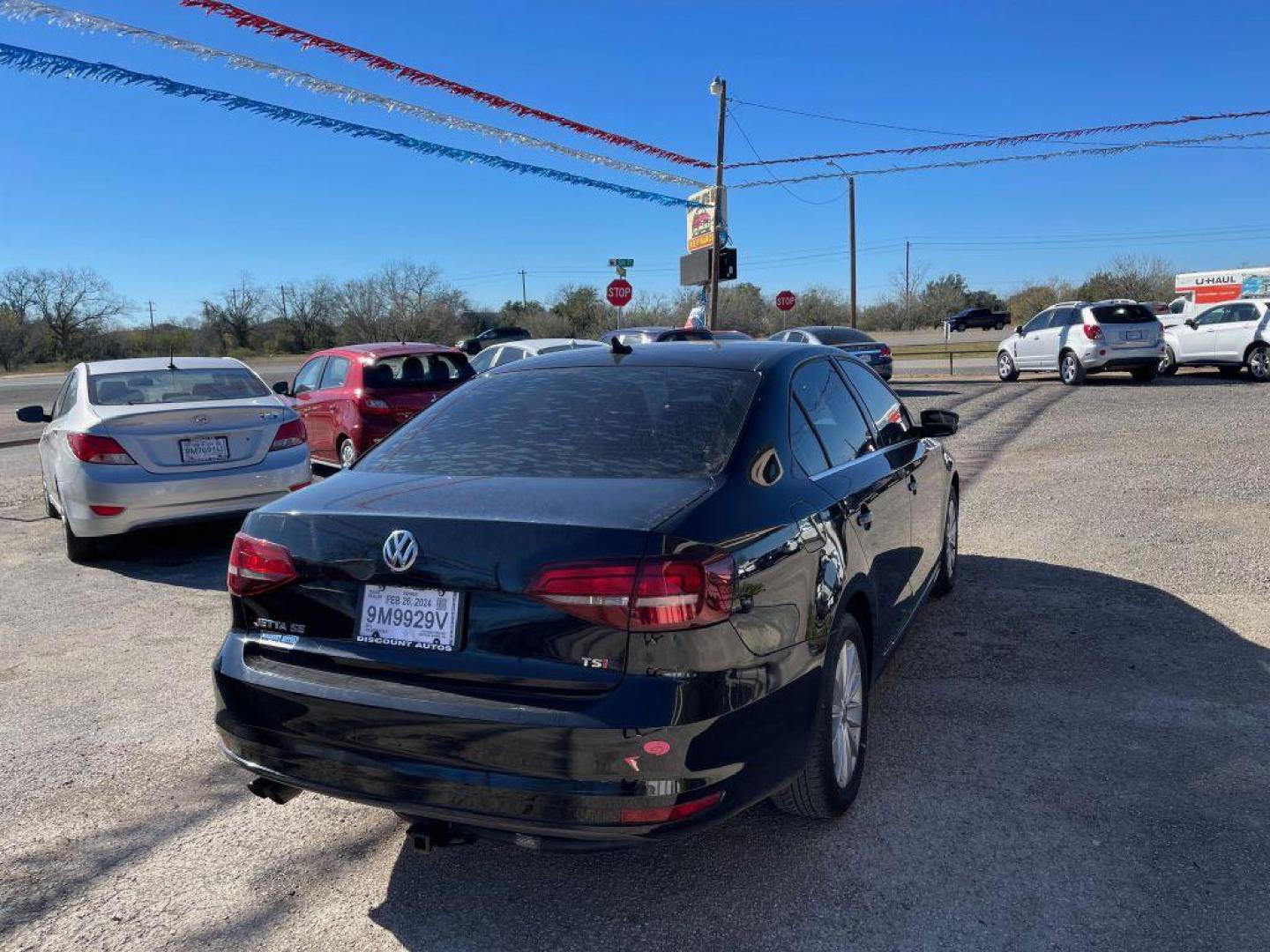 2016 BLACK VOLKSWAGEN JETTA SE (3VWD67AJ1GM) with an 1.4L engine, Automatic transmission, located at 124 Elm St., Cibolo, TX, 78108, (210) 658-3118, 29.559427, -98.232384 - www.discountautoscibolo.com TEXT 210-900-3118 41 MONTHLY PAYMENTS OF $320 WITH $2995 DOWN AND FINAL ODD PAYMENT OF $73.27 W/FIRST PAYMENT DUE 30 DAYS FROM DATE OF SALE. FEATURES: BACK UP CAMERA, SUN ROOF, HEATED LEATHER SEATS, BLUE TOOTH WARRANTY ON ENGINE and TRANSMISSION O - Photo#2